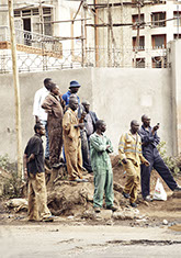 Men in a pyramid formation in colored jumpsuits in Nairobi, Kenya