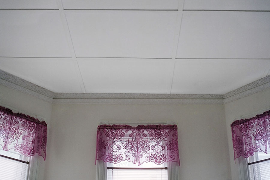 Digital Chromogenic Print. Color photograph, home interior, white ceiling tiles, octogon room, three windows, pink curtains, flower pattern