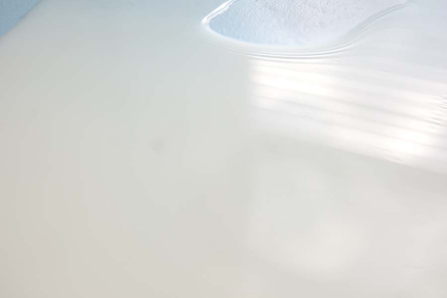 30" x 20" Archival Inkjet Print. Color photograph. Blue surface, white milk spilled, light, window reflection