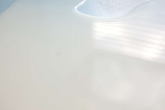 30" x 20" Archival Inkjet Print. Color photograph. Blue surface, white milk spilled, light, window reflection